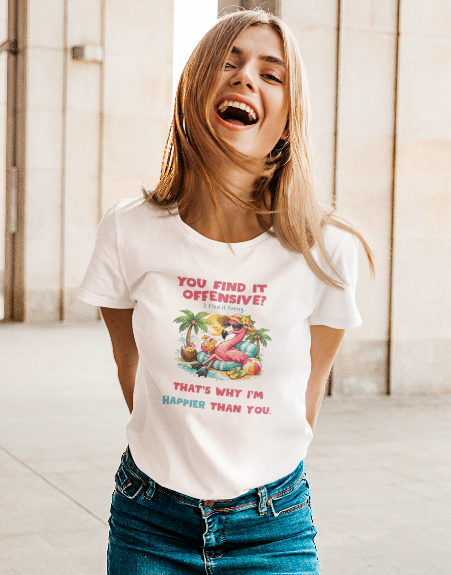 Woman wearing a white t-shirt with a colorful graphic and text, laughing indoors.